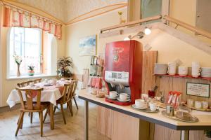 a restaurant with a table and a coffee machine at Pension Martha in Grein