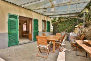 a wooden table and chairs on a patio at 5 Terre For You in Riomaggiore