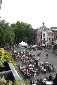 a large group of people sitting in a park at Stadshotel De Klok in Breda