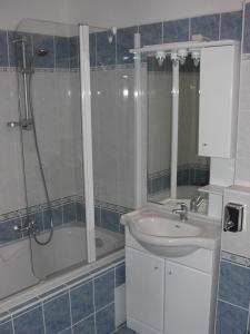 a bathroom with a shower and a sink and a tub at Lipnoapartments 88 in Lipno nad Vltavou