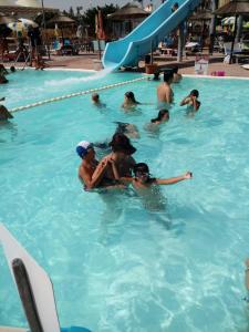 a group of people in a swimming pool at La Casa sul Molo in Viareggio
