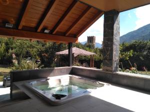 a hot tub on the patio of a house at Hotel La Ribera in Ribera de Cardós