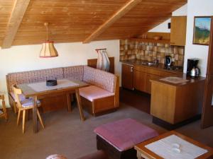 a living room with a table and a kitchen at Ferienhaus Antonia in Ehrwald
