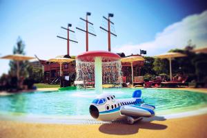 a toy car is sitting in the water at a water park at Crowne Plaza Vilamoura - Algarve, an IHG Hotel in Vilamoura