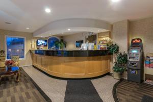 a lobby with a waiting area and an atm machine at Canadas Best Value Inn Chinook Station in Calgary