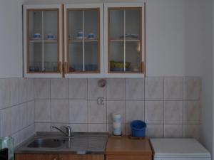 a kitchen with a sink and wooden counter top at Apartmani Adriana1979 in Vodice +16 photos