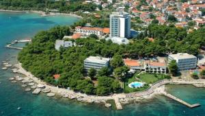 a small island in the water with a resort at Apartmani Adriana1979 in Vodice