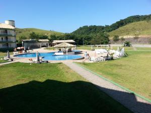 a view of a swimming pool in a resort at Flats no Quartier e Village Apart Hotel in Três Poços +3 photos