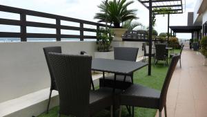 a table and chairs on top of a balcony at Sebastien Hotel in Mactan