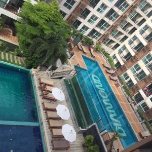 an overhead view of a swimming pool with umbrellas and a hotel at Diamond Suite in Pattaya South