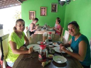 a group of people sitting at a table eating at Buyan Homestay in Sanur