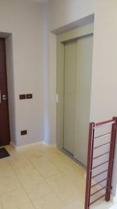 an empty room with two doors and a tile floor at La trifula bianca apts. in Alba