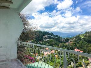 a balcony with a view of a city at Blinkbonnie Kandy in Kandy