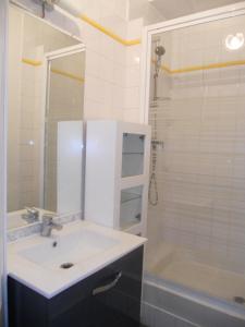 a white bathroom with a sink and a shower at au 303 in Lyon