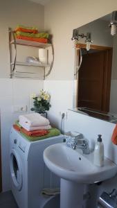 a bathroom with a washing machine and a sink at El Fraile in Tejeda