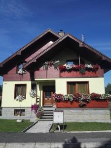 a house with flower boxes on the front of it at Homestay Adele in Nová Lesná
