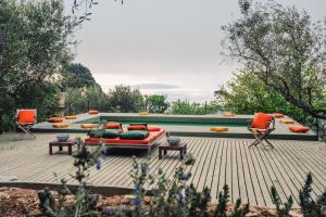 a patio with a couch and chairs and a pool at Borgo degli Ulivi in Porto Ercole