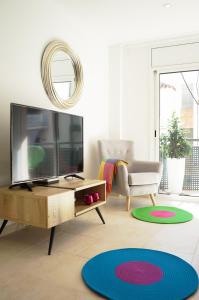 a living room with a television and a couch at Matilda Home on the Beach in Sitges