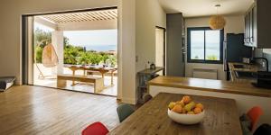 a kitchen with a table with a bowl of fruit on it at Santa Rosa in Les Issambres
