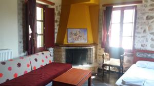 a living room with a couch and a fireplace at Casa Lanoi in Syrrako