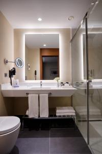 a bathroom with a sink, toilet and bathtub at Point Hotel Ankara in Ankara