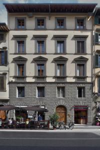 a large building with tables in front of it at Residenza Conte di Cavour & Rooftop in Florence