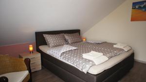 a bedroom with a bed with pillows and a night stand at Ferienhaus Dreilinge in Cochem