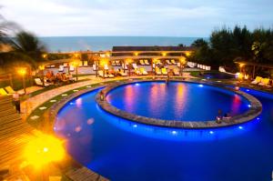 a large pool with blue lighting in a resort at Long Beach in Canoa Quebrada
