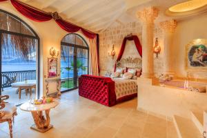 a bedroom with a bed and a tub in a room at Lukka Exclusive Hotel – Adult Only +12 in Kaş