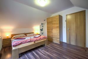 a bedroom with a large bed and a wooden closet at Apartmány Barto21 in Bartošovice v Orlických Horách