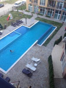 an overhead view of a swimming pool with a person in it at Sanny view South- Студия Мир авангарда in Sunny Beach