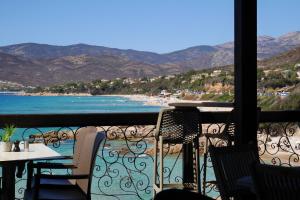 a balcony with a table and chairs and a beach at A Cittadella in Vico