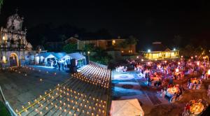 a group of people sitting at tables at night at Amatique Bay Hotel in Puerto Barrios