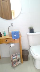 a bathroom with a sink and a toilet and a mirror at Sítio Sapiranga in Sapiranga +40 photos