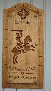 a wooden cutting board with drawings of animals on it at Gite du Chevalier du fort st ours in Loches