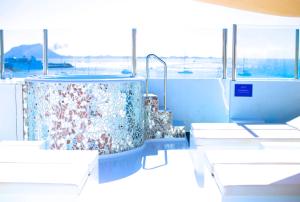 a group of tables and chairs in a room at AVANTI Lifestyle Hotel - Only Adults in Corralejo