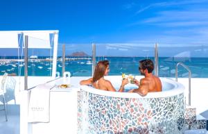 a man and a woman sitting in a bath tub at AVANTI Lifestyle Hotel - Only Adults in Corralejo