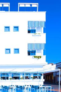 a white building with tables and chairs in front of it at AVANTI Lifestyle Hotel - Only Adults in Corralejo +37 photos