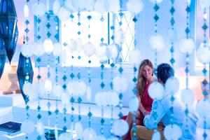 two women sitting in a room with white balloons at AVANTI Lifestyle Hotel - Only Adults in Corralejo