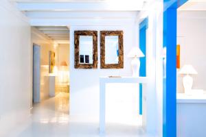 a room with white walls and a mirror on the wall at AVANTI Lifestyle Hotel - Only Adults in Corralejo
