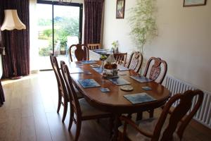 a dining room with a wooden table and chairs at River Edge B&B in Jamestown