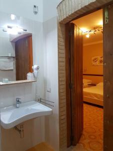 a bathroom with a sink and a room with a bed at Agriturismo Masseria Mascitelli in Orta Nova