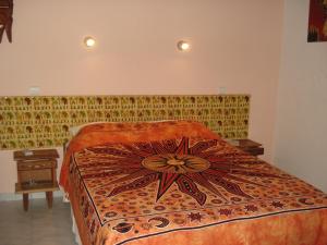 a bedroom with a bed and two night stands at Bolongs Passion in Cap Skirring