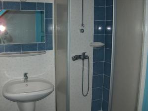 a bathroom with a sink and a shower at Apartmanház Sipos Siófok in Siófok +11 photos