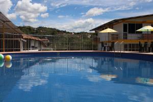 a large blue swimming pool in front of a house at Eco Hotel El Ocaso in Valle de San José