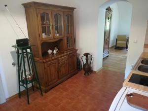 a kitchen with a large wooden cabinet in a room at Apartma 5 in Radovljica