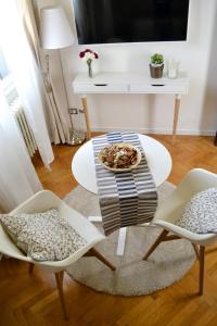 a living room with a table and chairs and a desk at Domus Duomo in Florence