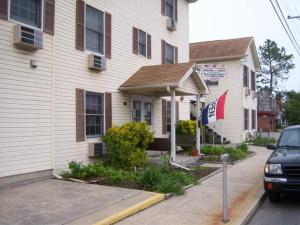 a white house with a sign in front of it at Summer Place Hotel in Rehoboth Beach