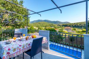 a table on the balcony with a view of the mountains at Holiday Home Gata 7 in Gata