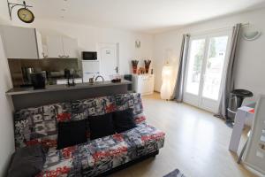 a living room with a couch and a kitchen at Gite Bibou in Peille